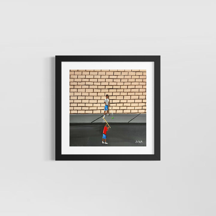 two boys playing outside game with stick and ball in street in front of brick wall