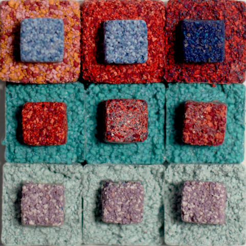 colorful volcanic rock pink blue green pastel squares grid red dark blue 