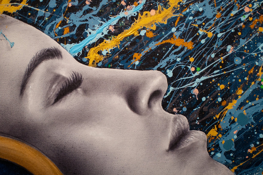 woman side profile face in black and white wearing gold headphones with sea scene flipping hair back in blue black and gold splatter paint on white background
