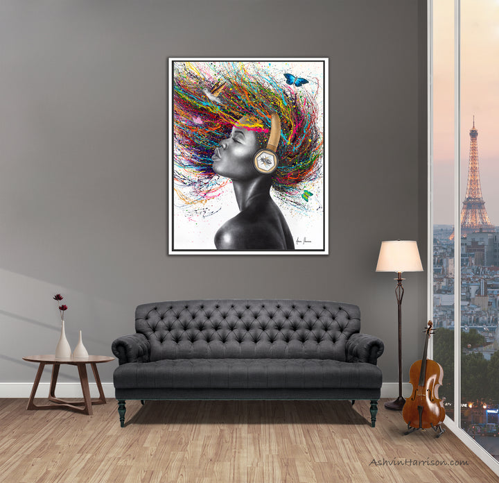 Beautiful woman wearing headphones painted in coconut charcoal, with bright rainbow colored paint splattered as hair, butterflies and hummingbird
