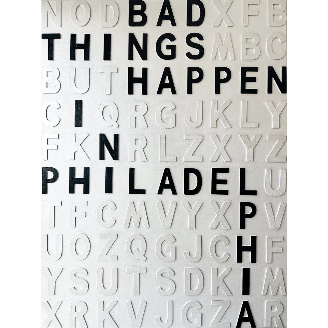 Steffanie Gerkin’s Bad Things White 3D is a contemporary mixed-media typography artwork made with raised wood and acrylic letters on canvas, featuring a white alphabet grid with bold black letters that spell “Bad Things Happen in Philadelphia.”