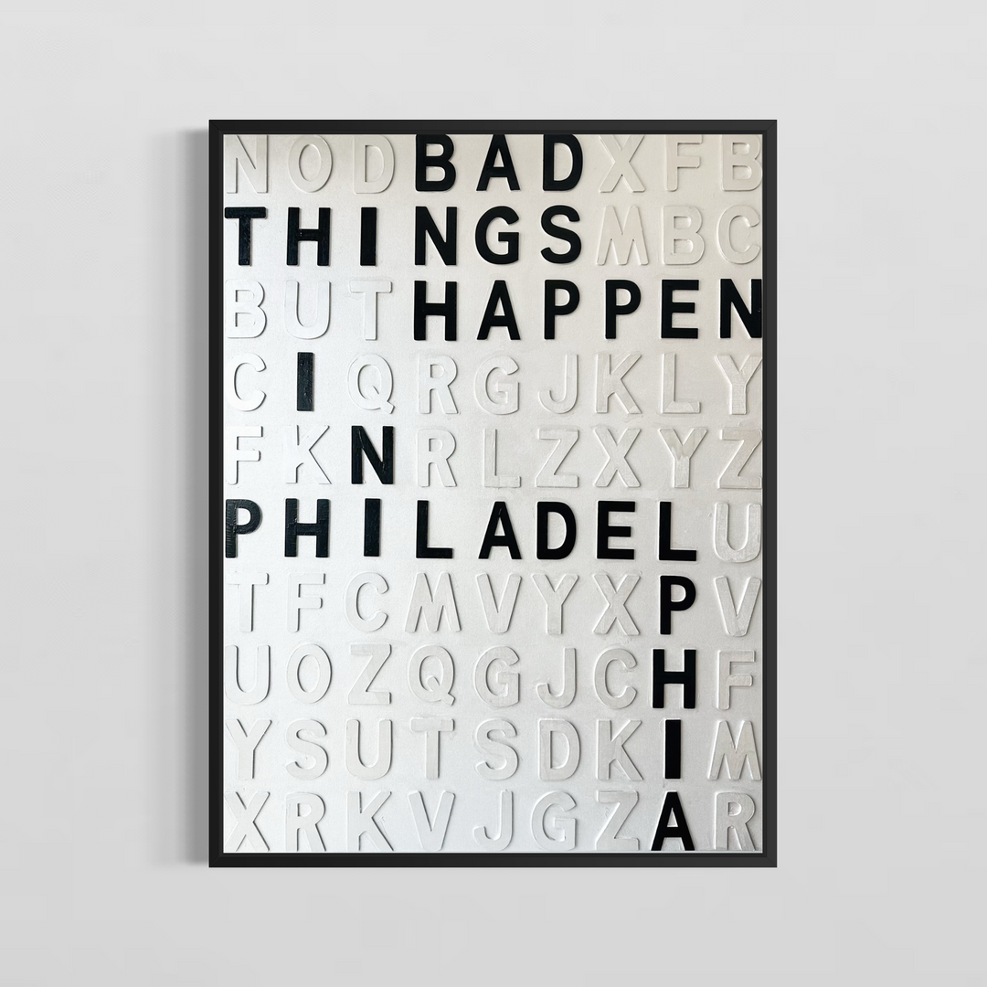 Steffanie Gerkin’s Bad Things White 3D is a contemporary mixed-media typography artwork made with raised wood and acrylic letters on canvas, featuring a white alphabet grid with bold black letters that spell “Bad Things Happen in Philadelphia.”