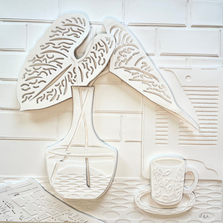 14"x14" layered white paper forming a a vase with leaves on a wall. 