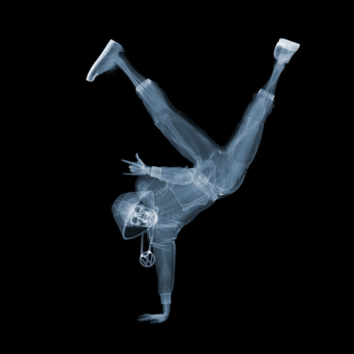 x ray photograph figure skeleton breakdancer pose rock on symbol with chains on black background pop art surrealism 