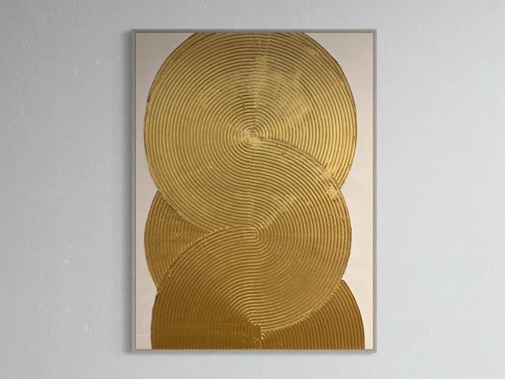 Continuity by Lee in Cerulean. Textured and geometric painting of overlapping gold circles on a white background.
