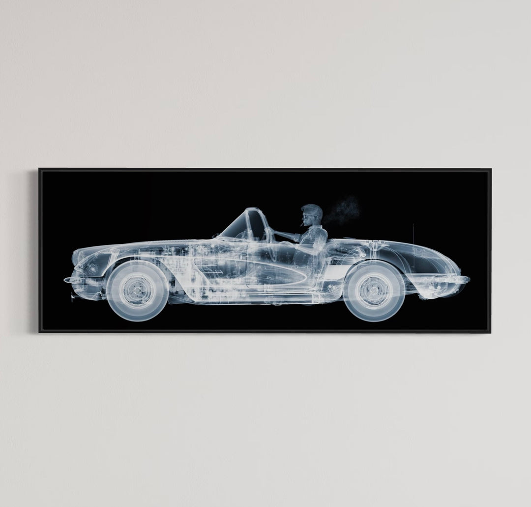 Framed Chromaluxe black and white x-ray photograph by Nick Veasey of a skelton man driving a vintage corvette cruiser while spoking a cigarette