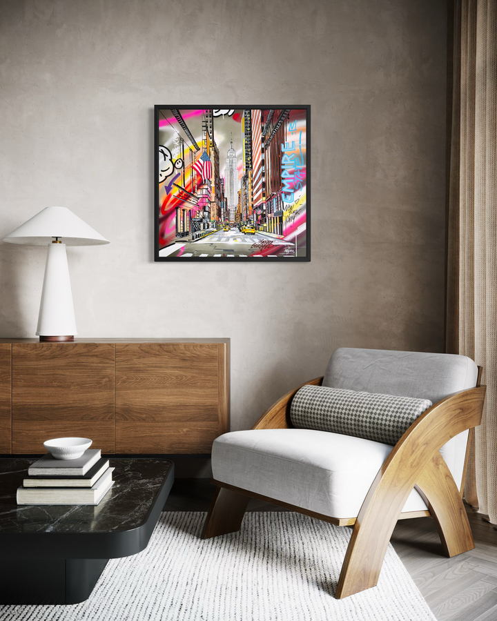 Framed "Empire State of America" graffiti painting by Pappay displayed above a wooden credenza in a modern living room