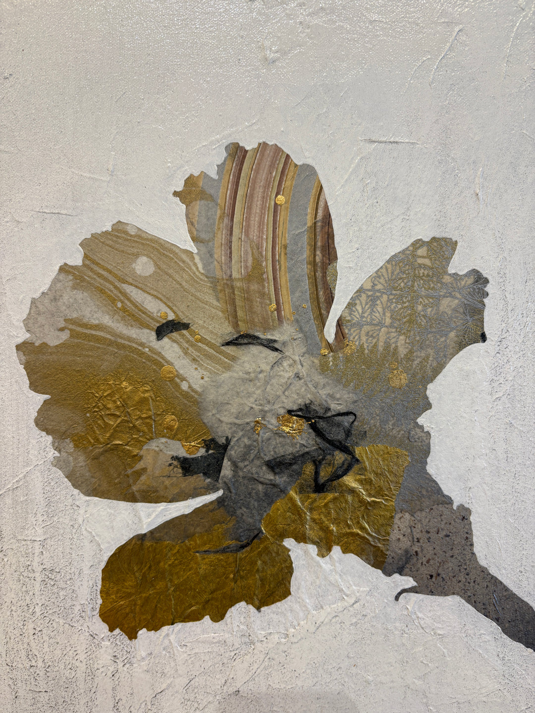 "Floral Profile" by Christopher Peter — a mixed-media collage painting on canvas depicting an elegant botanical stem of layered flowers crafted from gold leaf and marbled paper against a soft plaster-textured ivory background. Original contemporary mixed-media gold leaf botanical floral painting on canvas available at Morton Contemporary gallery.