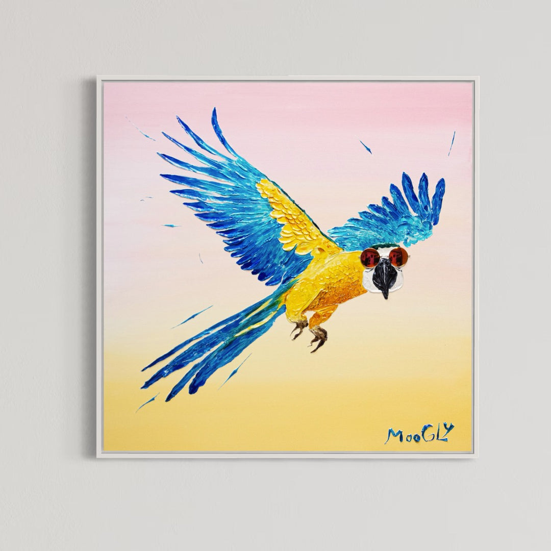 30” x 30” painting by French artist Moogly of a blue and yellow parrot in sunglasses with a pink and yellow ombre background. The parrot is depicted in mid-flight and made out of resin, giving it a textured and shiny finish. The sunglasses are real round, reflective sunglasses that the artist has adhered to the canvas.