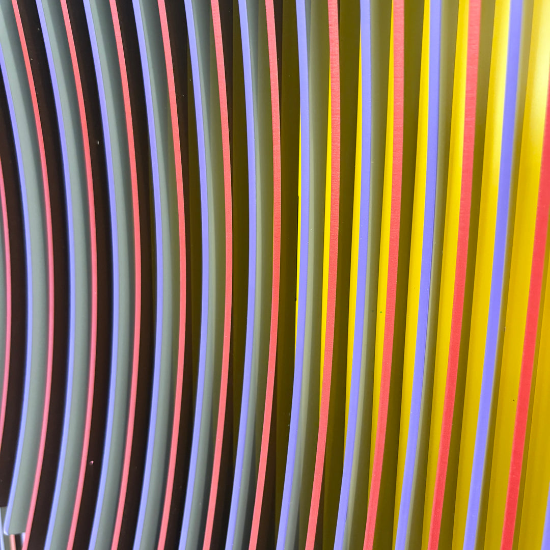 geometric abstract vertical lines concave optical illusion of a circular shape in middle in yellow red and blue