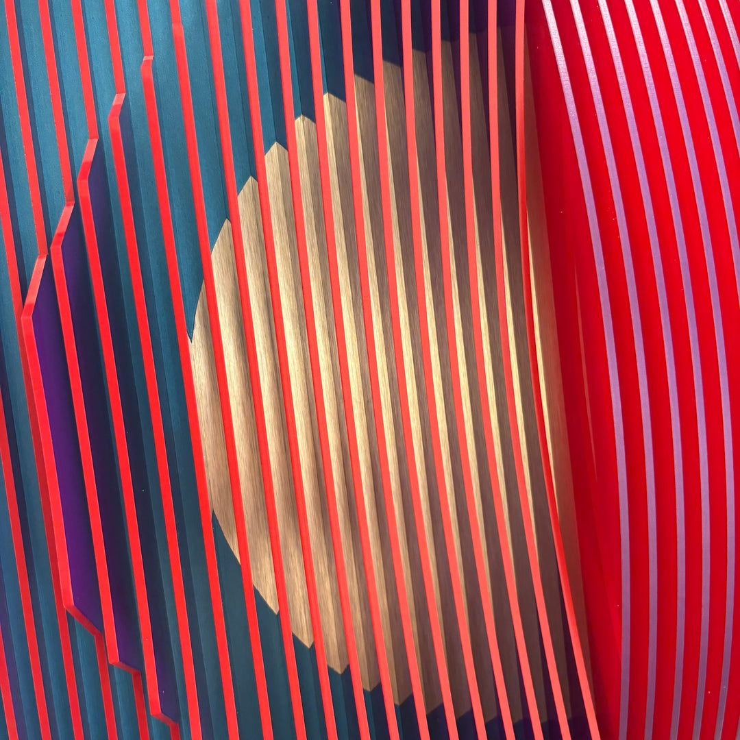 3 dimensional circular shape in center of vertical stripes square composition in red and blue white then when turned to side mostly red emerges optical illusion space color