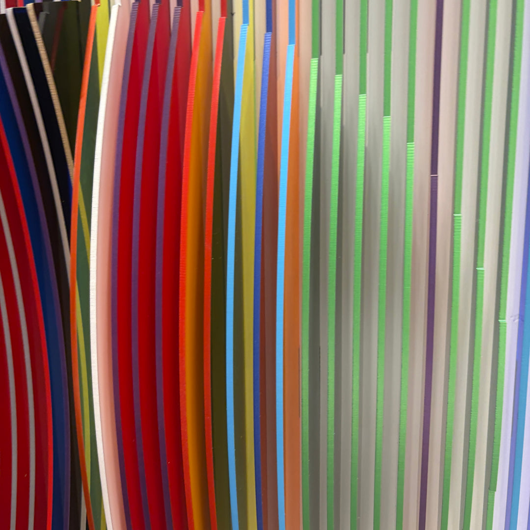 from view vertical stripes on white background in rainbow colors all convex and concave optical illusion to create circle from front, jagged from side and color more prominent
