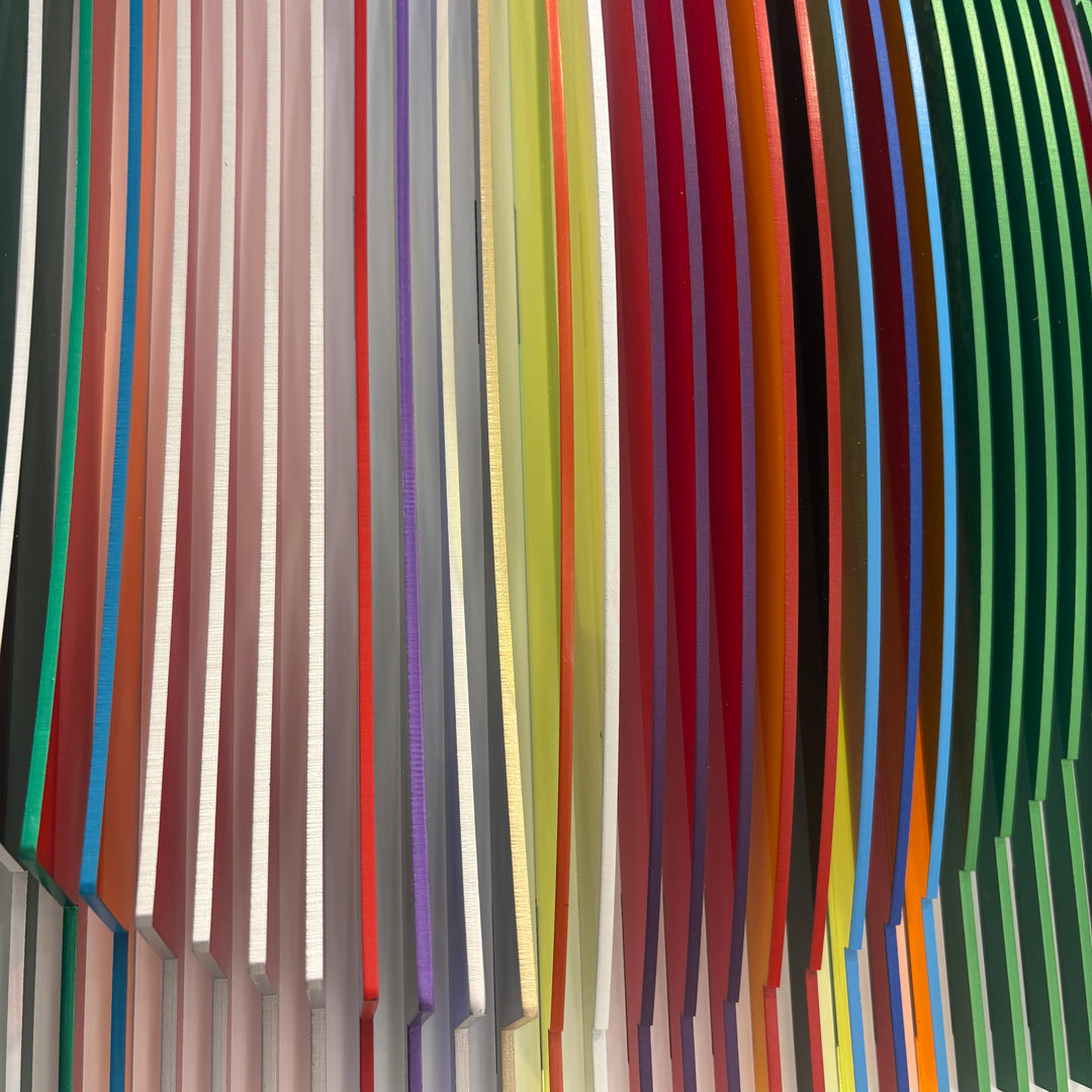 from view vertical stripes on white background in rainbow colors all convex and concave optical illusion to create circle from front, jagged from side and color more prominent
