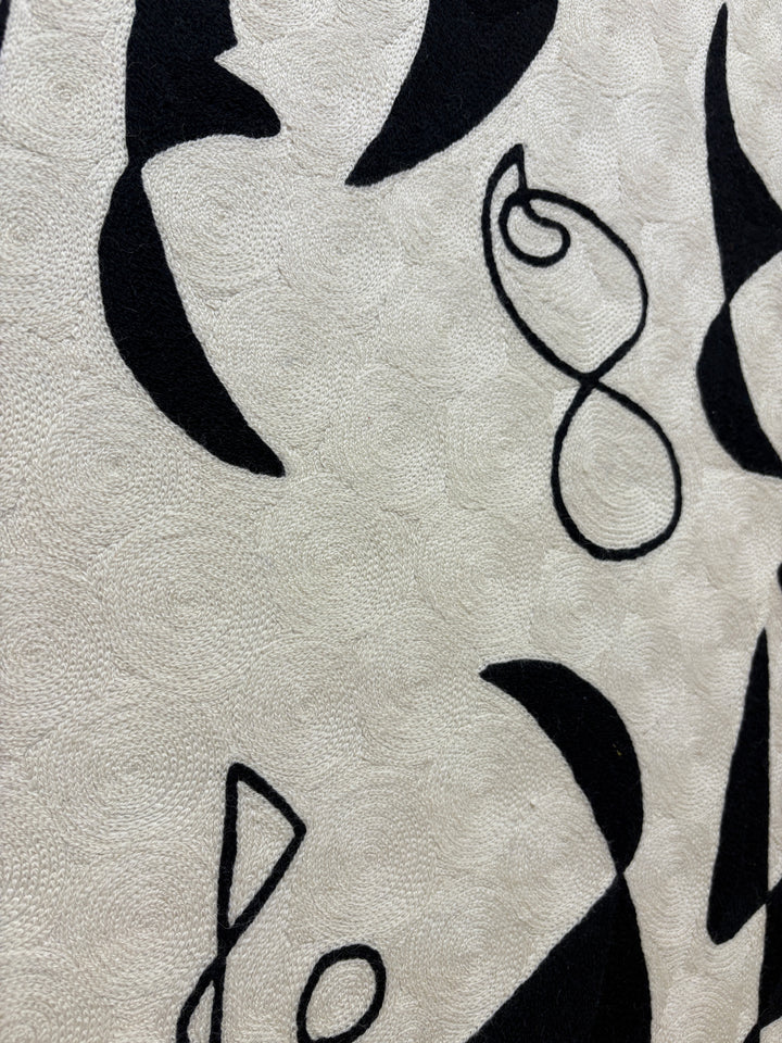 abstract shapes doodles line work in black and white negative space solid heavy chain stitched textile fabric embroidery