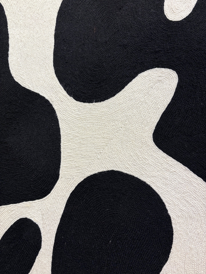 chain stitched textile embroidery abstract black and white negative space pattern shapes in wood frame