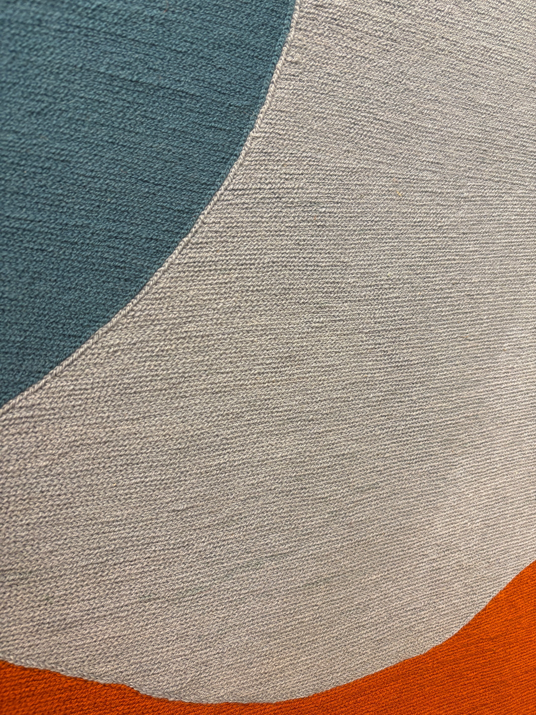 chain stitched embroidery fabric textile framed geometric abstraction blue green orange shapes negative space