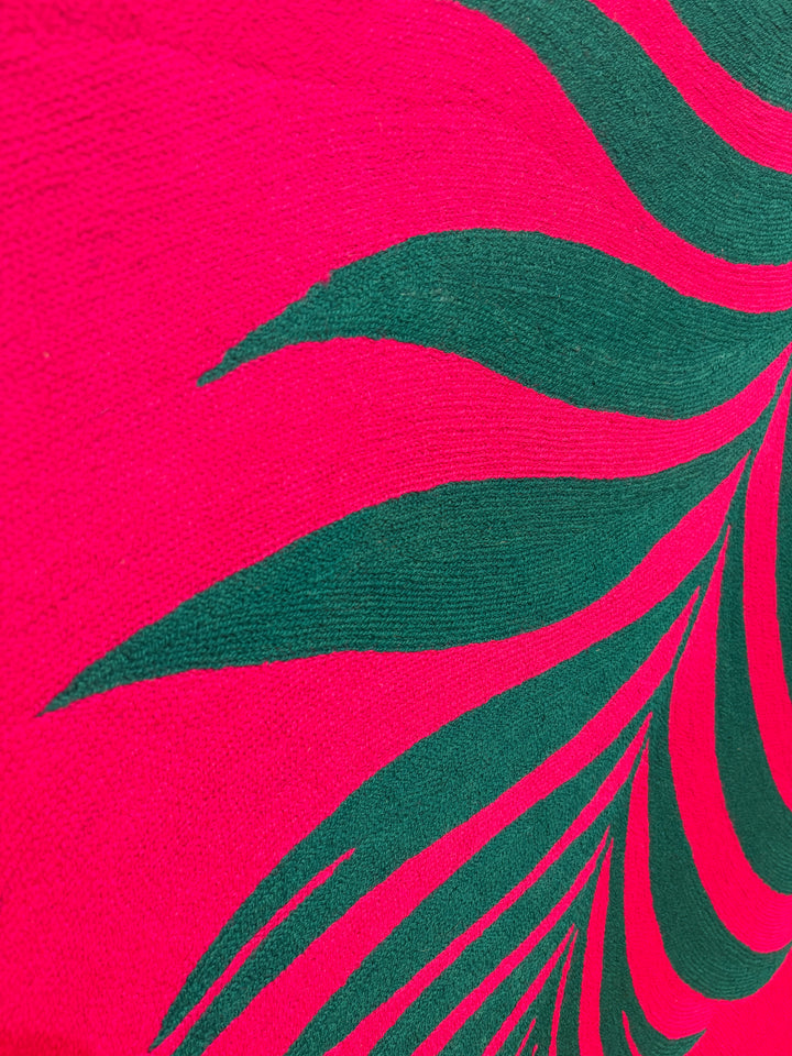 42.5"x42.5" chain-stitched textile with a tropical leaf over a bright pink background. 