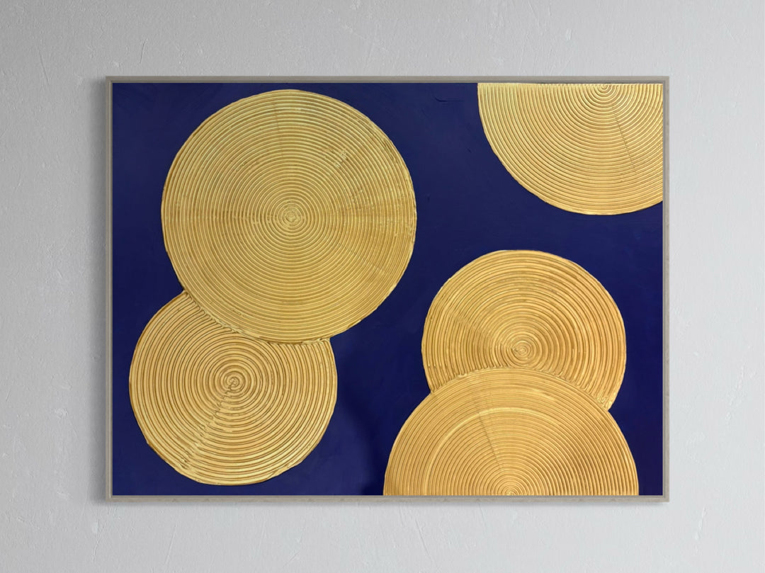 Indigo Awakening II by Lee in Cerulean. Acrylic mixed media painting of textured golden circles, overlapping on top of a dark blue background.