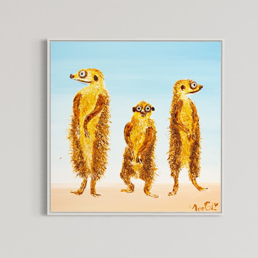 30” x 30” painting by French artist Moogly of three goldish-brown merecats. The two merecats on the sides look left and right while the smallest one in the middle looks straightforward with a light blue background. The merecats are made out of resin, giving them a textured and shiny finish. Their eyes are made out of washers that the artist has adhered to the canvas.