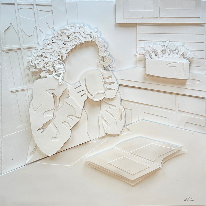 14"x14" layered white paper forming a woman drinking coffee and reading. 