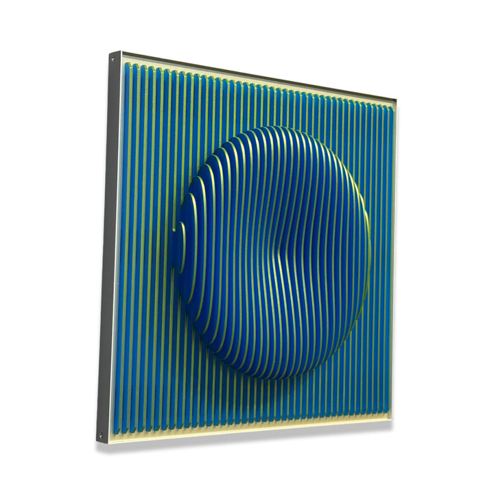 vertical green stripes with 3 dimensional circular shape emerging from center, when viewed from side ridges are blue optical illusion geometric abstraction sculpture