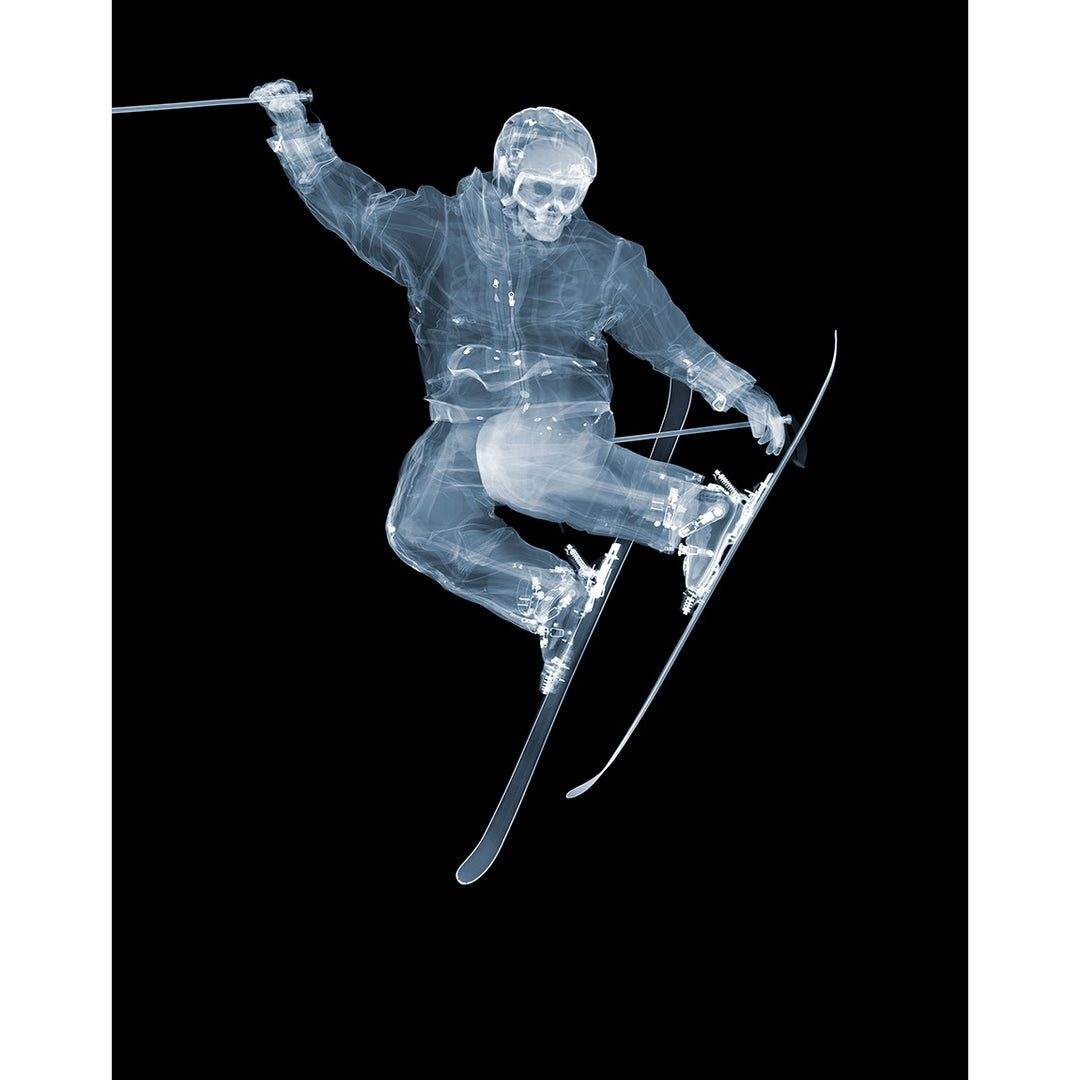 Framed Chromaluxe x-ray photograph by Nick Veasey of a skeleton skier jumping on a black background