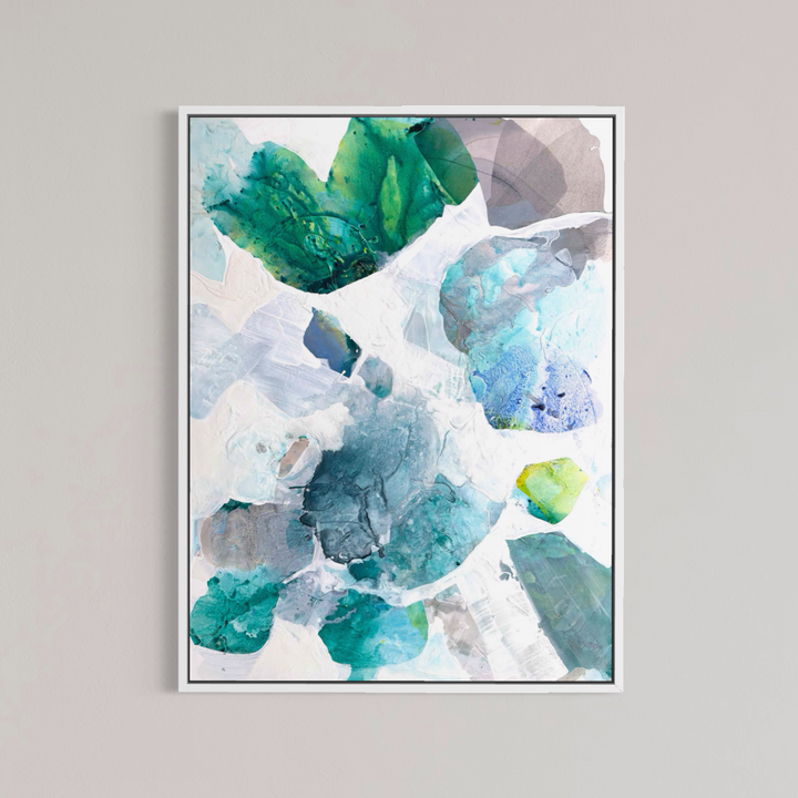 Liz Barber, Sun Bloom 5, acrylic paint, ink, watercolor, and graphite on canvas, 36 x 48 inches. Vertical abstract composition of overlapping rounded shapes in emerald green, teal, sky blue, periwinkle, mauve gray, and lime green scattered across a white background, shown in a thin white frame on a light gray wall.
