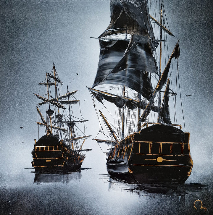 "Travelling" by French artist Julien Rey — a mixed-media painting on board of two tall ships at sea, crafted with Chinese lacquer and gold leaf. Two dramatic black galleons with billowing sails and gold leaf rigging emerge from a misty silver-gray ocean, their hulls and stern details richly accented in gold. Seabirds drift through the atmospheric haze above still, reflective waters. Original contemporary nautical tall ship painting on board available at Morton Contemporary gallery.