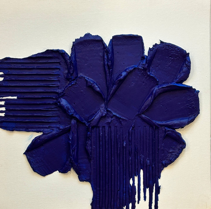 Layered blue joint compound with lines scraped out on sides on white background