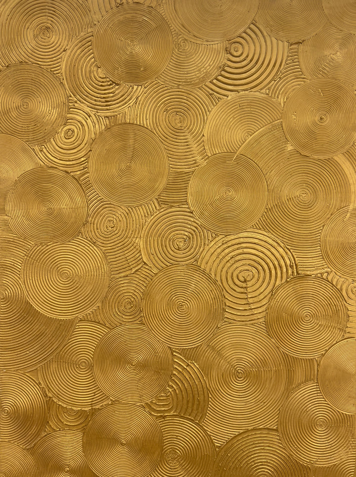 Visionary by Lee in Cerulean. Textured painting of gold circles, overlapping with smaller circles within creating a spiraled and whimsical effect.