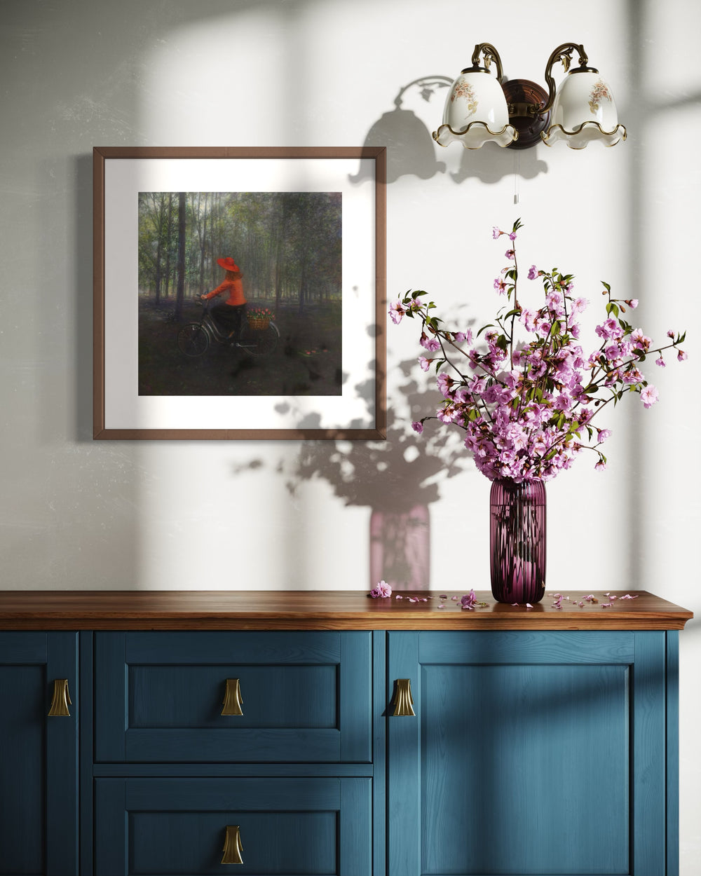 Girl in red shirt and hat riding bike with flowers in back through dark wooded green area shadows and slivers of light showing between trees oil landscape nature painting