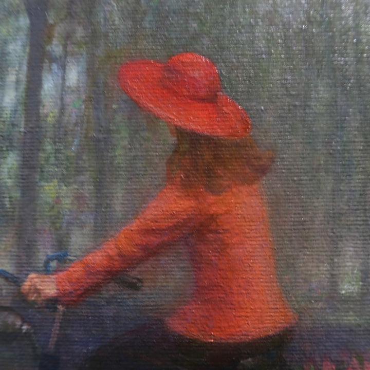 Girl in red shirt and hat riding bike with flowers in back through dark wooded green area shadows and slivers of light showing between trees oil landscape nature painting
